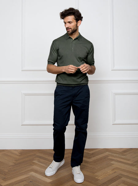 Man wearing palm green short sleeved polo neck knit in a luxury and premium 100% merino wool.